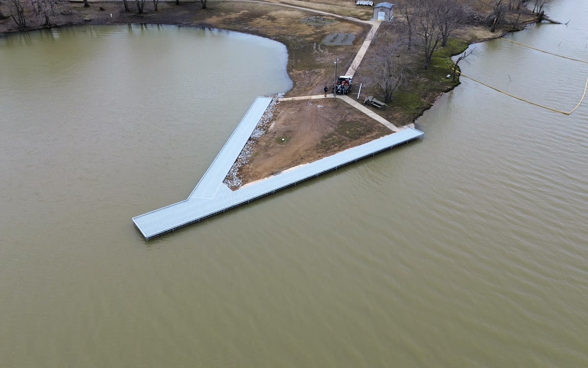 Aerial view of a long V-shaped Twin Lakes walkway pier built out from a shoreline