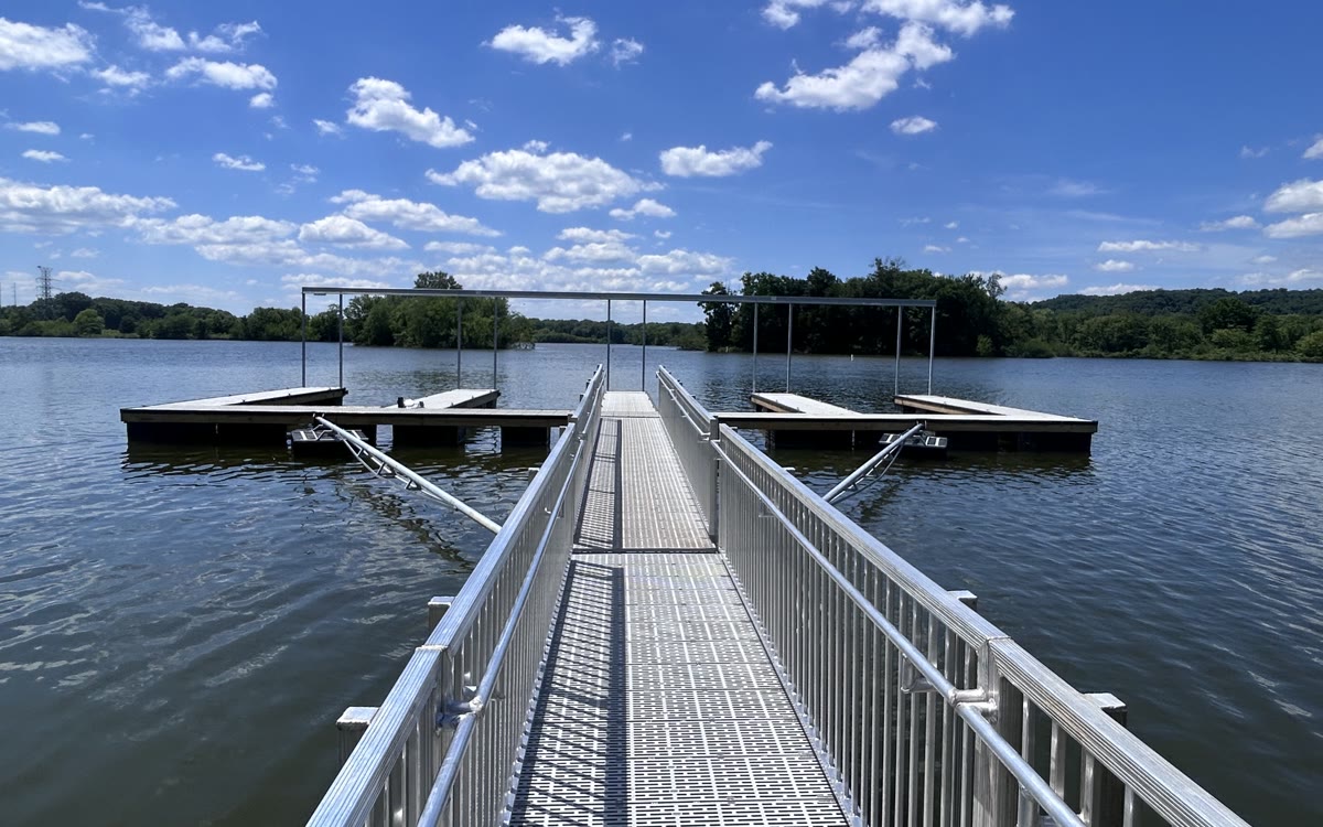 A public two-slip Twin Lakes dock with an aluminum walkway and handrails on both sides