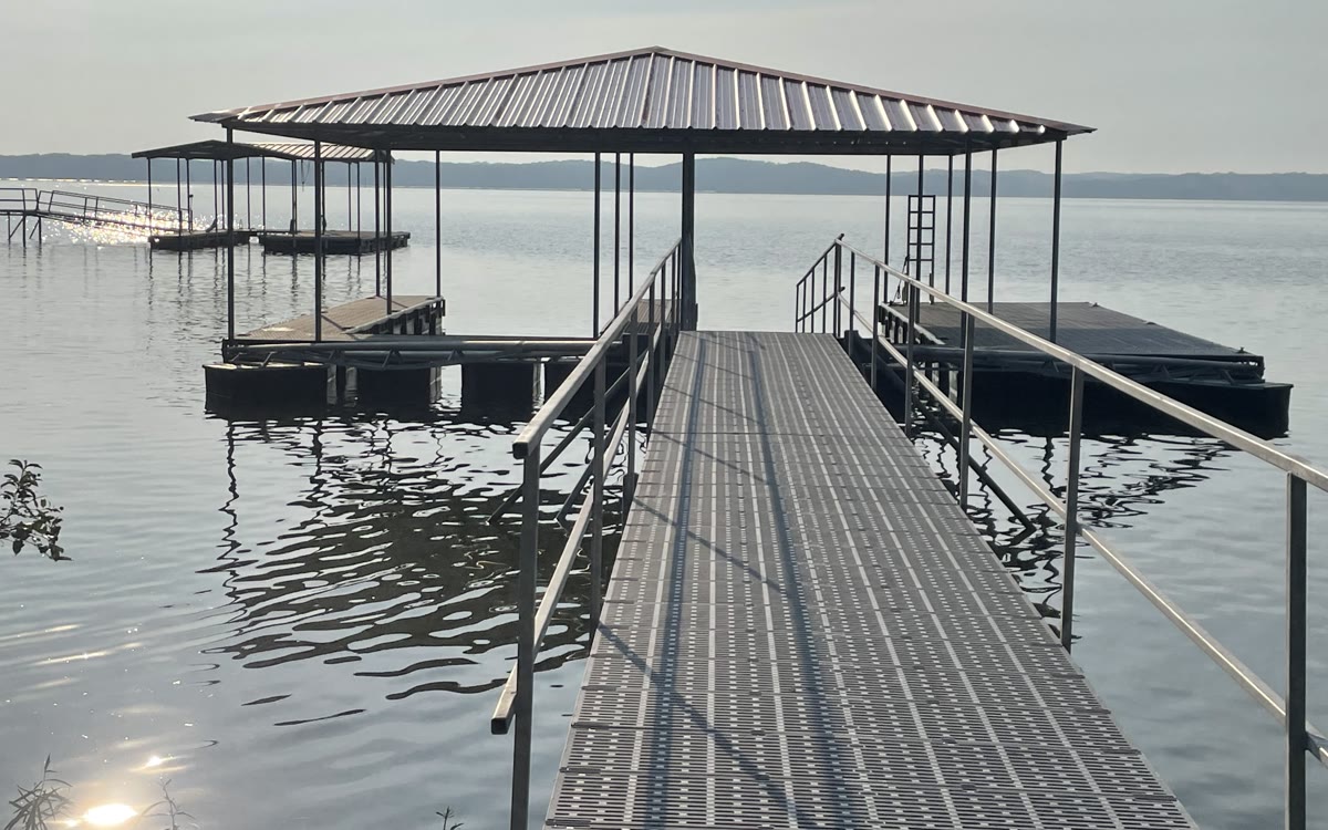 A covered Twin Lakes boat slip and Thruflow walkway on Kentucky Lake in early morning light